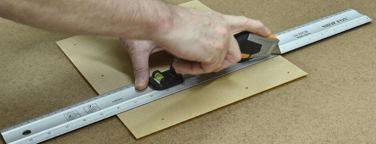 Scoring a cut line on acrylic with a utility knife